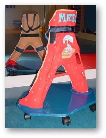 Custom red stander with support straps on a wheeled platform