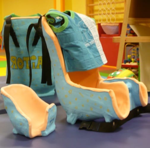 Custom-moulded pelvic seats with a support vest in the clinic room