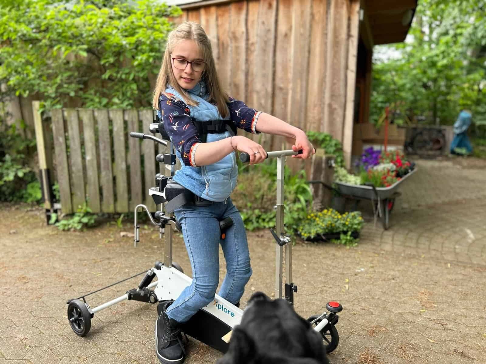 A teenager practises walking with the Xplore in the garden