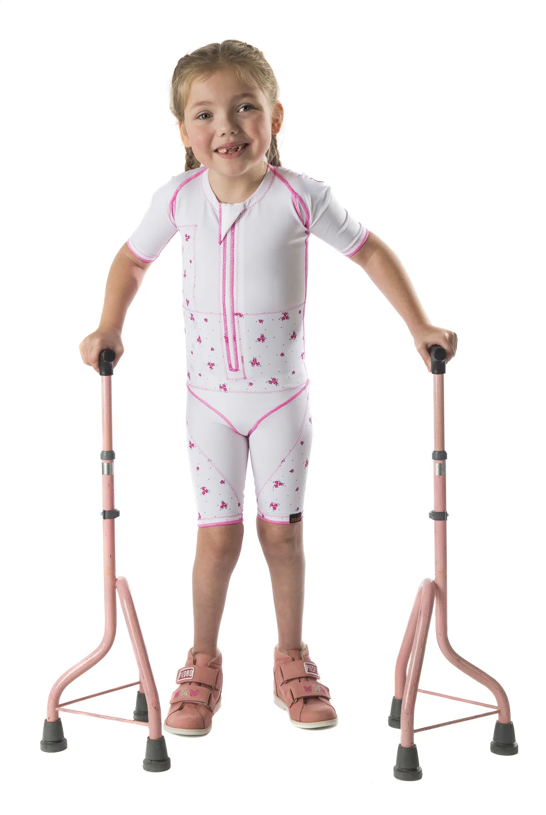 Girl wearing a pink and white dynamic suit walking with two crutches