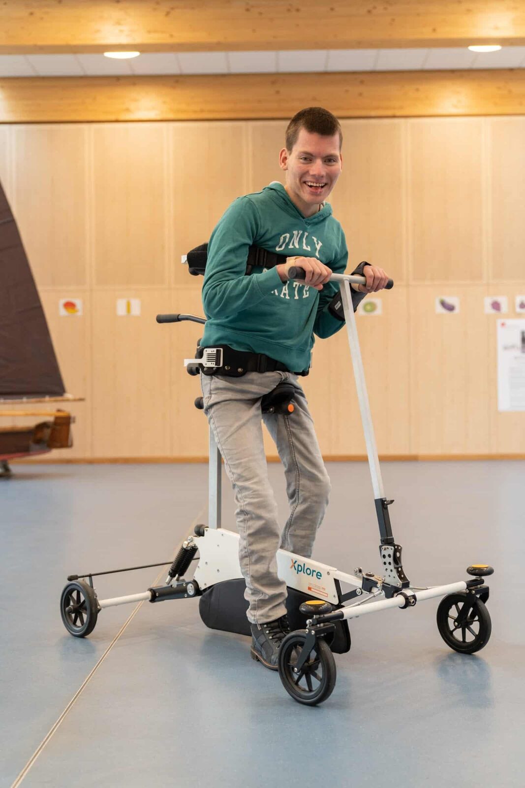 A young adult trains with the Xplore in a sports hall